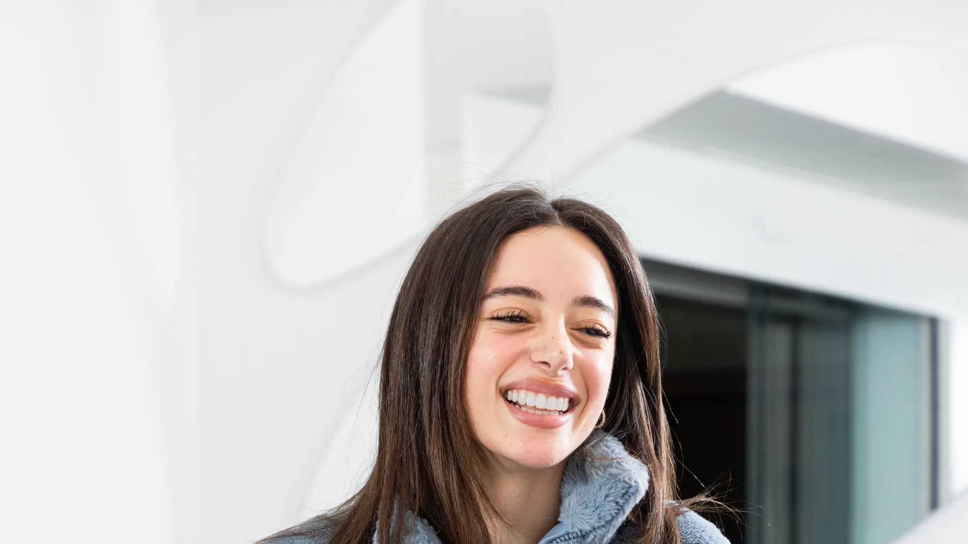 A smiling patient leaning on the Cliniform reception counter