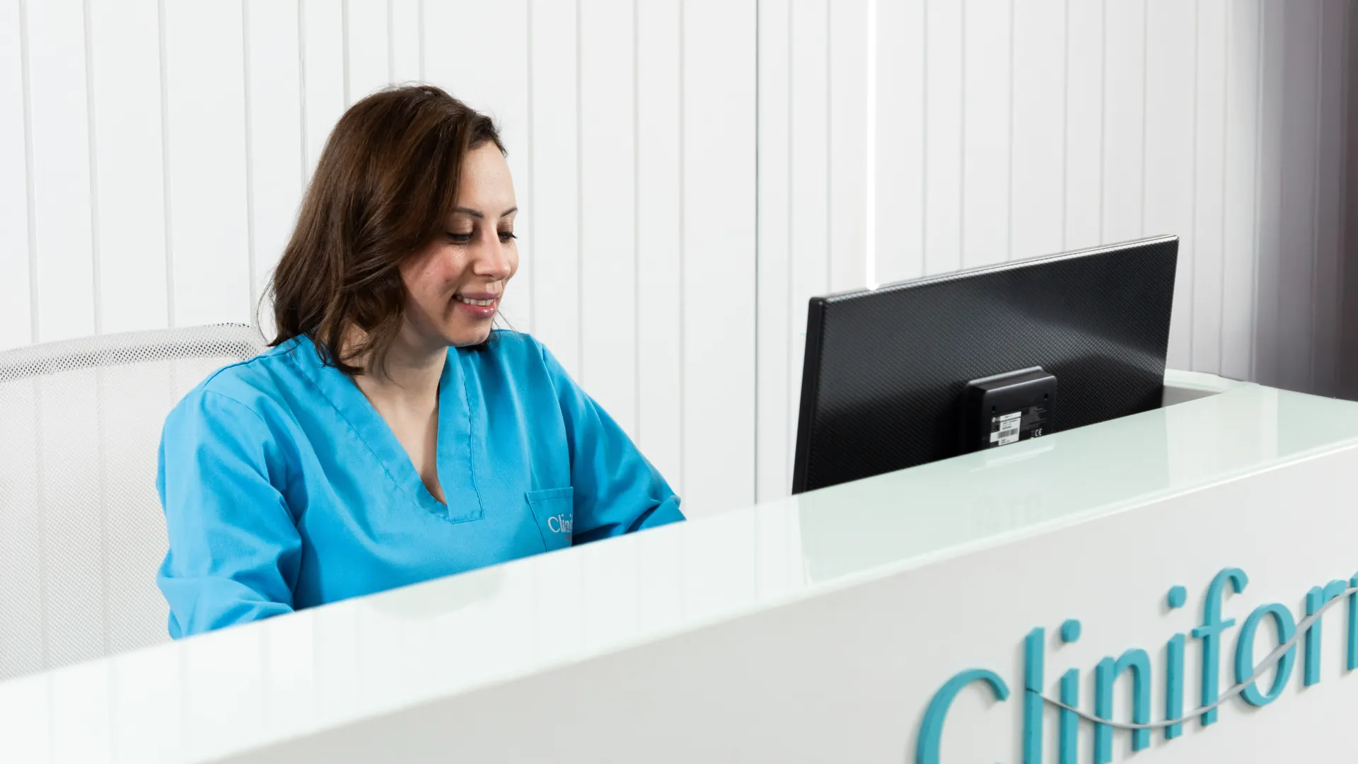 Cliniform receptionist at the branded reception desk